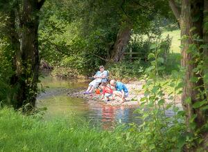 Family enjoying the river at Rockbridge Country Park